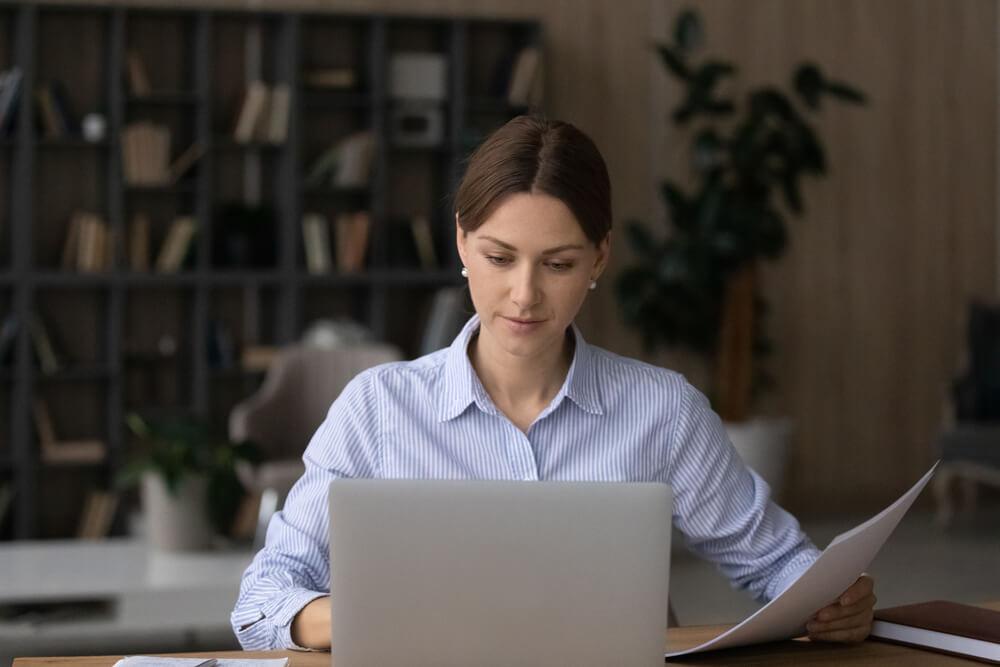 Woman with a form and a computer