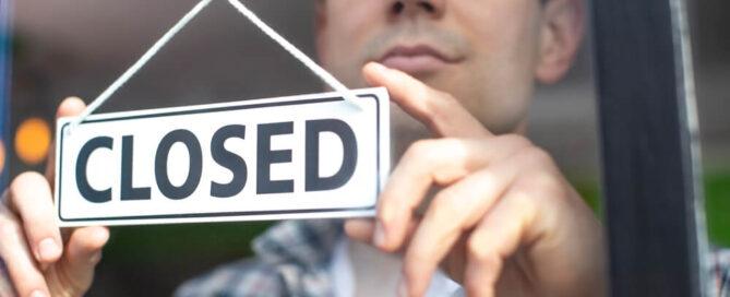 Man with a closed sign