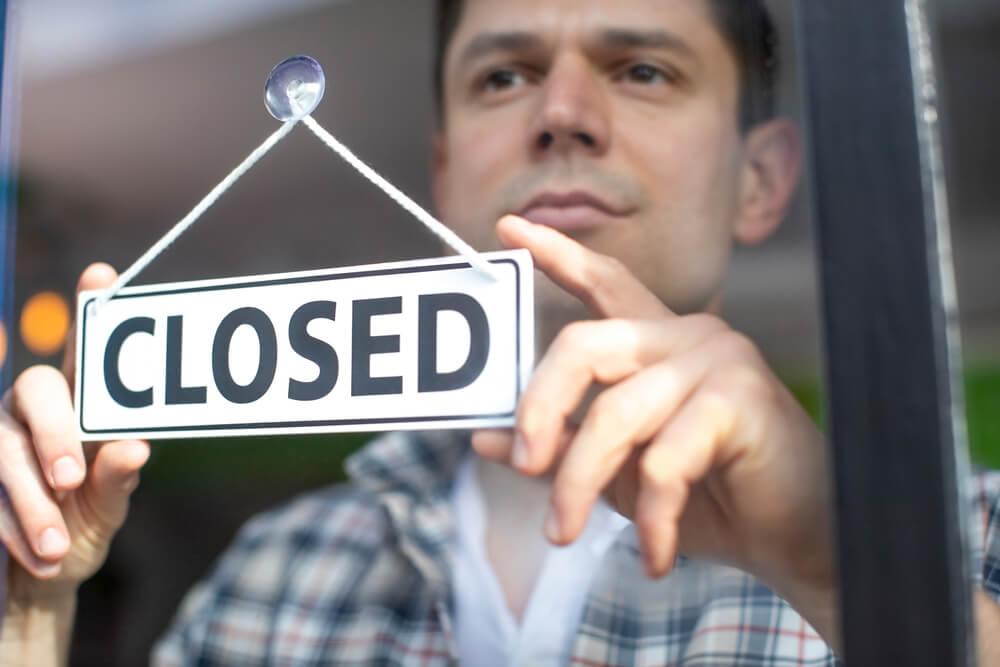 Man with a closed sign