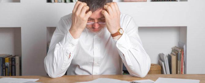 Sad manager with debts