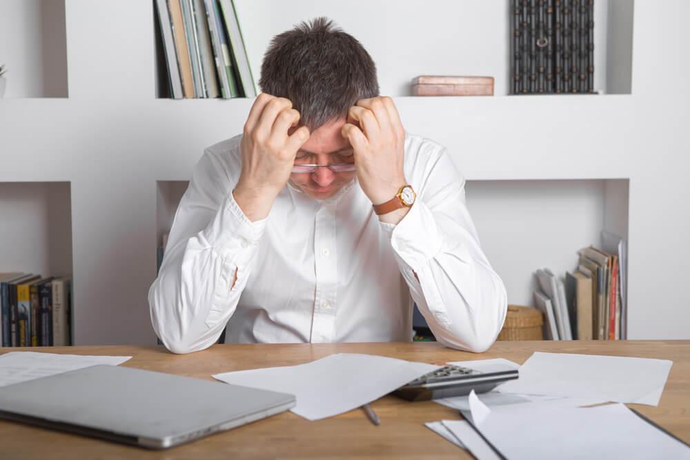 Sad manager with debts