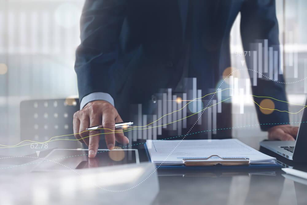 Business man calculating assets