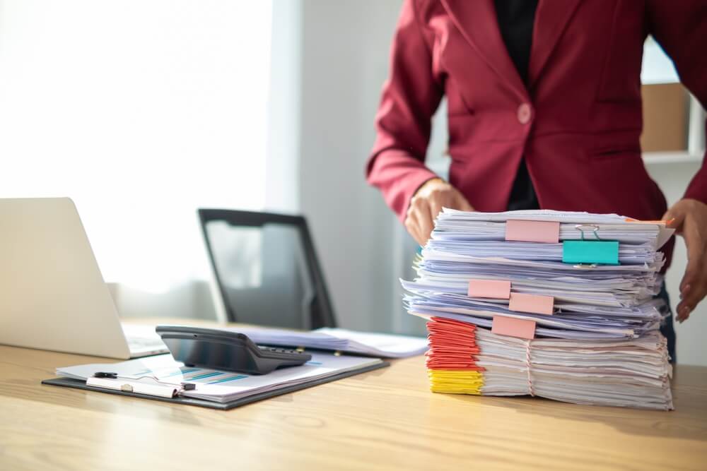 Company director with a pile of documents