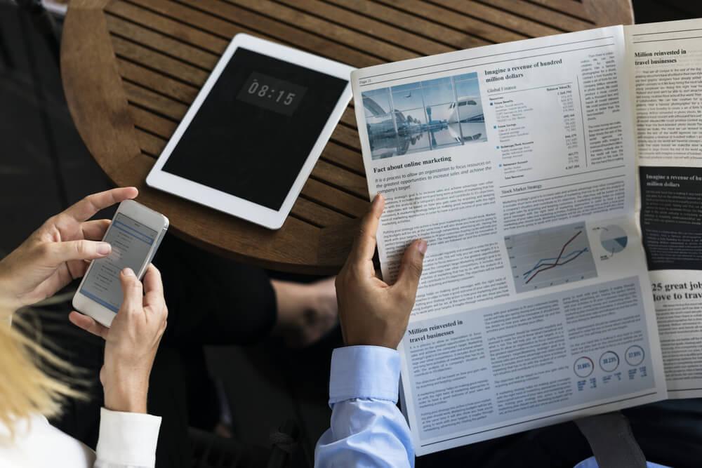 Business people reading the newspaper