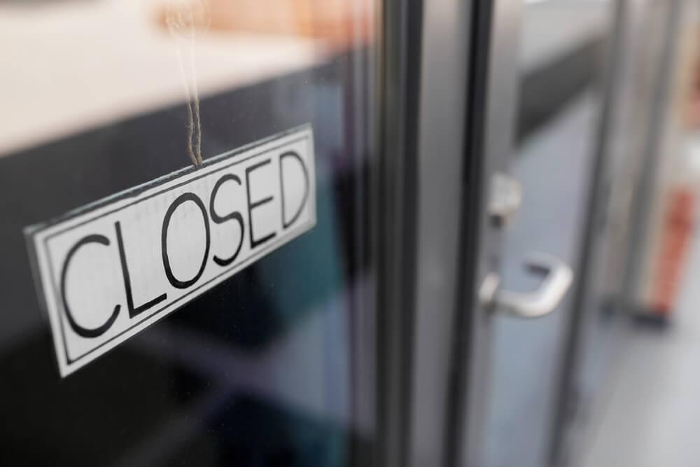 small business, pandemic and service concept - close up of closed sign on office door